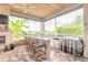 Elegant outdoor kitchen with a stone countertop, modern appliances, and a scenic view overlooking the lush landscape at 2913 Linari Ct, New Smyrna Beach, FL 32168