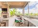 Outdoor kitchen featuring a built-in grill, sink, and mini-fridge with an inviting view of the backyard at 2913 Linari Ct, New Smyrna Beach, FL 32168