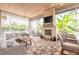 Cozy screened-in lanai features a stone fireplace, comfortable seating, and view of the pool at 2913 Linari Ct, New Smyrna Beach, FL 32168