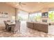 Screened outdoor patio with dining set, fireplace, TV, and comfortable seating area at 2913 Linari Ct, New Smyrna Beach, FL 32168