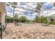 Screened in pool and brick patio with palm tree views, perfect for outdoor relaxation and entertainment at 2913 Linari Ct, New Smyrna Beach, FL 32168
