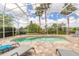 Relaxing screened pool with tanning ledge and brick patio, ideal for enjoying sunny days and cool evenings at 2913 Linari Ct, New Smyrna Beach, FL 32168