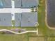 Bird's eye view of a well-maintained backyard with pavers, lush grass, and direct access to a community walking trail at 3136 Portofino Blvd, New Smyrna Beach, FL 32168