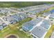 Expansive aerial view of a Primary-planned community with beautiful homes and lush landscaping near a tree conservation at 3136 Portofino Blvd, New Smyrna Beach, FL 32168