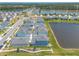 Breathtaking aerial view of a Primary-planned community with lovely ponds, lush landscaping, and sidewalks at 3136 Portofino Blvd, New Smyrna Beach, FL 32168