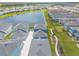An aerial view showcases the homes, lake, and landscaping of the community at 3136 Portofino Blvd, New Smyrna Beach, FL 32168