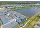 A picturesque aerial view showcasing a Primary-planned community featuring a lake and beautifully designed homes at 3136 Portofino Blvd, New Smyrna Beach, FL 32168
