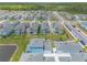 An aerial view shows the homes, lake, and landscaping of this beautiful community at 3136 Portofino Blvd, New Smyrna Beach, FL 32168