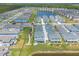 Gorgeous aerial view of a Primary-planned community featuring scenic ponds, sidewalks and beautiful two-story homes at 3136 Portofino Blvd, New Smyrna Beach, FL 32168