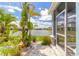 View of the landscaped backyard and pond from the screened-in porch of this beautiful home at 3136 Portofino Blvd, New Smyrna Beach, FL 32168