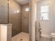 Elegant bathroom with a large tiled shower featuring a glass enclosure and hexagon tile flooring at 3136 Portofino Blvd, New Smyrna Beach, FL 32168