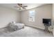Bedroom with a ceiling fan, carpeted floor, a bed and TV at 3136 Portofino Blvd, New Smyrna Beach, FL 32168