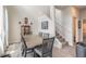 Cozy dining room with seating for six, next to a staircase leading up to the next level at 3136 Portofino Blvd, New Smyrna Beach, FL 32168