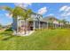 Beautiful blue home featuring a screened-in porch and professional landscaping in a well-maintained community at 3136 Portofino Blvd, New Smyrna Beach, FL 32168