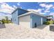 View of the detached two-car garage and paved driveway of this well-maintained home at 3136 Portofino Blvd, New Smyrna Beach, FL 32168
