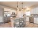 Modern kitchen features granite countertops, stainless steel appliances, and a functional island with seating at 3136 Portofino Blvd, New Smyrna Beach, FL 32168