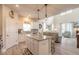 Open-concept kitchen with island and seating, seamlessly flowing into the well-lit living room at 3136 Portofino Blvd, New Smyrna Beach, FL 32168