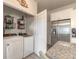 Convenient laundry room with washer, dryer, and storage shelves adjacent to granite countertops at 3136 Portofino Blvd, New Smyrna Beach, FL 32168