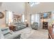 Bright living room boasts high ceilings, comfortable seating, and ample natural light for a welcoming atmosphere at 3136 Portofino Blvd, New Smyrna Beach, FL 32168