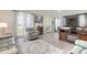Inviting living room featuring cozy seating, stylish decor, and abundant natural light from large windows at 3136 Portofino Blvd, New Smyrna Beach, FL 32168