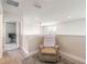 Bright loft area features neutral paint, wood-look floors, and is furnished with a beige recliner at 3136 Portofino Blvd, New Smyrna Beach, FL 32168