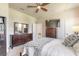 Comfortable main bedroom featuring a ceiling fan, dresser, and plush bedding at 3136 Portofino Blvd, New Smyrna Beach, FL 32168
