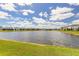 View of the serene pond featuring a fountain and lush green surroundings at 3136 Portofino Blvd, New Smyrna Beach, FL 32168