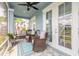 View of the cozy screened porch featuring comfortable wicker furniture and ample space at 3136 Portofino Blvd, New Smyrna Beach, FL 32168