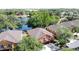Aerial view of a two-story home with an orange exterior and an attached two-car garage near a lake at 3311 Pine Oak Trl, Sanford, FL 32773