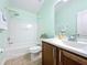 Well-lit bathroom features a shower-tub combo, wood vanity with a white sink, and a medicine cabinet at 3311 Pine Oak Trl, Sanford, FL 32773