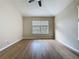 This bedroom has wood-look floors and a double window with blinds overlooking the exterior at 3311 Pine Oak Trl, Sanford, FL 32773