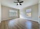 Bedroom with wood floors, fan and two windows at 3311 Pine Oak Trl, Sanford, FL 32773