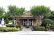 Charming community building surrounded by lush landscaping and manicured bushes at 3311 Pine Oak Trl, Sanford, FL 32773
