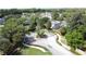 Aerial view of a landscaped community entrance with a circular median and brick fencing and manicured lawns at 3311 Pine Oak Trl, Sanford, FL 32773