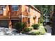 Exterior view of townhomes, manicured landscaping, sidewalks, and lake views in the background at 3311 Pine Oak Trl, Sanford, FL 32773