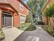 Front exterior of a townhome featuring manicured landscaping, a covered entry and a dark colored front door at 3311 Pine Oak Trl, Sanford, FL 32773