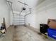 Spacious garage with overhead storage, white walls, and an automatic garage door at 3311 Pine Oak Trl, Sanford, FL 32773