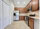 Modern kitchen with stainless steel appliances, stylish cabinetry, and tile floors at 3311 Pine Oak Trl, Sanford, FL 32773