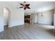 Open concept living room with modern ceiling fan and wood flooring at 3311 Pine Oak Trl, Sanford, FL 32773
