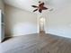 Cozy living area with wood-look floors and adjacent hallway at 3311 Pine Oak Trl, Sanford, FL 32773