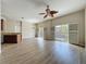 Open floorplan with kitchen and living room featuring wood-look floors, and ceiling fan at 3311 Pine Oak Trl, Sanford, FL 32773