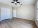 This main bedroom has wood-look floors, a window and a closet with double doors at 3311 Pine Oak Trl, Sanford, FL 32773