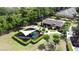 Aerial view of the playground with sunshade, surrounded by green grass and mature trees at 3311 Pine Oak Trl, Sanford, FL 32773
