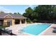 Community pool area with a covered lounge, sun deck and mature landscaping at 3311 Pine Oak Trl, Sanford, FL 32773