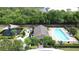 Aerial view of the community pool with lounge chairs and landscaped surroundings at 3311 Pine Oak Trl, Sanford, FL 32773