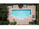 Aerial view of community pool with brick patio and ample lounge chairs at 3311 Pine Oak Trl, Sanford, FL 32773