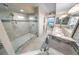 Bright bathroom showcasing a luxurious glass shower, double sink vanity and tub with stylish tile accents at 3311 S Atlantic Ave # 801, Daytona Beach, FL 32118