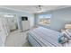 Bright bedroom with view, featuring a chest of drawers and bathroom access at 3311 S Atlantic Ave # 801, Daytona Beach, FL 32118