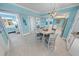 Cozy dining area with a table, chairs, stylish light fixture, and an open view of the modern kitchen at 3311 S Atlantic Ave # 801, Daytona Beach, FL 32118