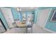 Charming dining area features a round table with seating for four, bright lighting, and a balcony view at 3311 S Atlantic Ave # 801, Daytona Beach, FL 32118